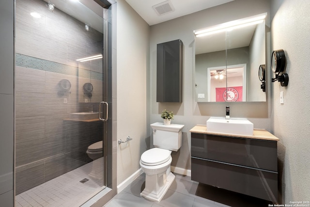 bathroom featuring vanity, toilet, a shower with shower door, and tile patterned flooring