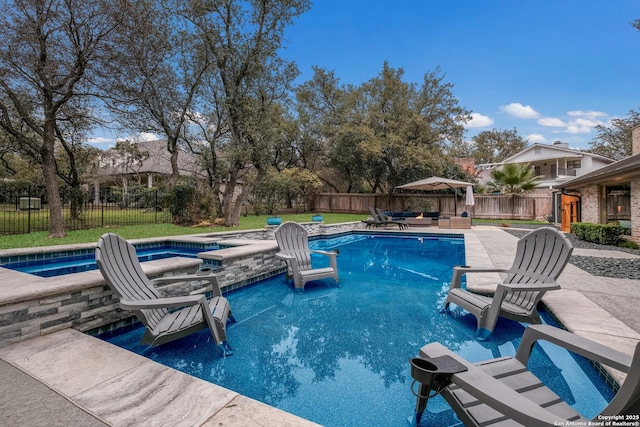 view of swimming pool featuring a patio and an in ground hot tub