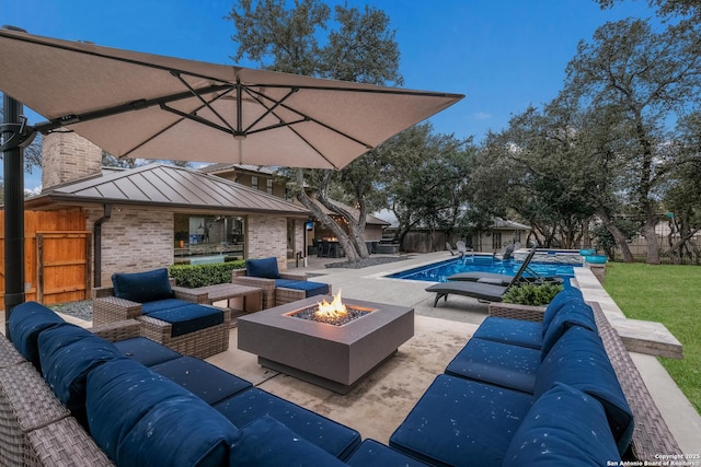 exterior space with a patio area and an outdoor living space with a fire pit