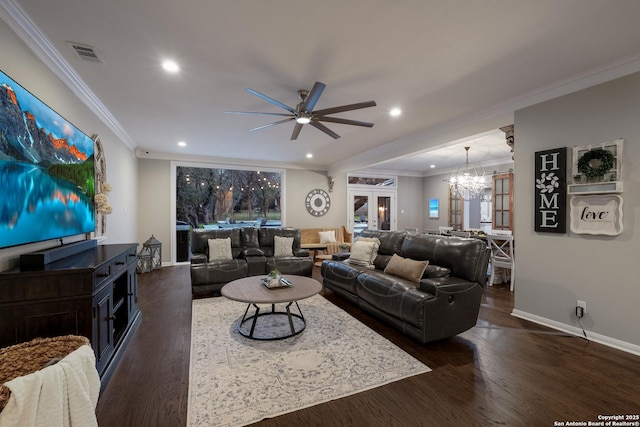 living room featuring crown molding, dark wood-type flooring, and ceiling fan with notable chandelier