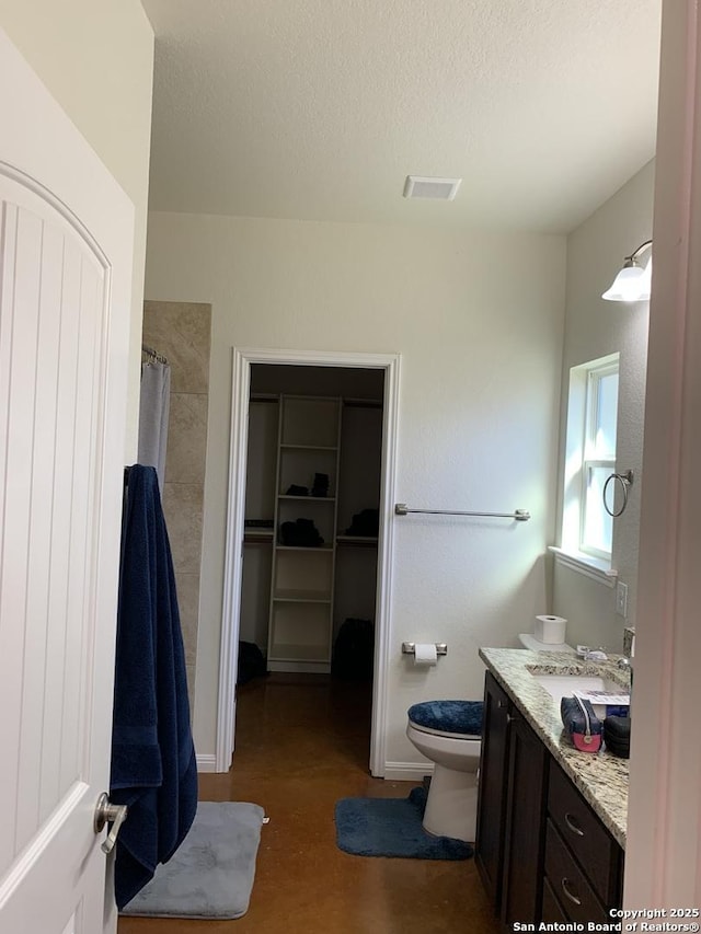 bathroom with hardwood / wood-style floors, a shower with shower curtain, vanity, a textured ceiling, and toilet