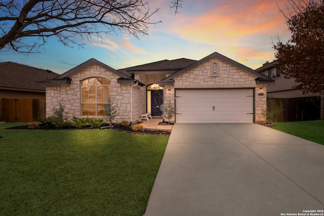 ranch-style home with a garage and a lawn