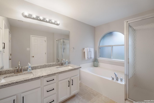 bathroom with tile patterned floors, vanity, and separate shower and tub