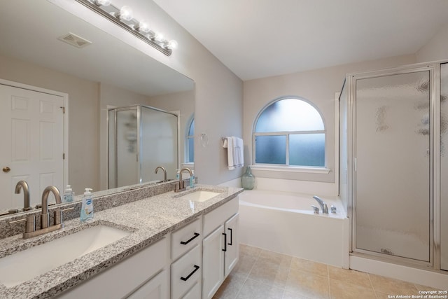 bathroom with tile patterned flooring, vanity, and separate shower and tub