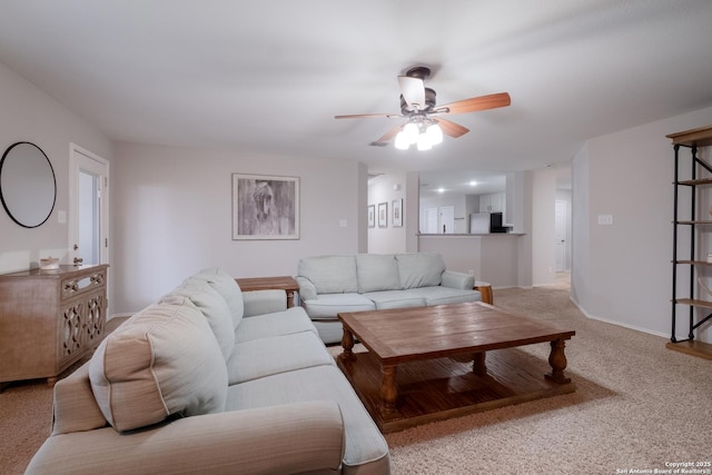 carpeted living room with ceiling fan