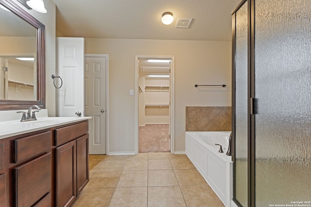 bathroom with tile patterned flooring, vanity, and plus walk in shower