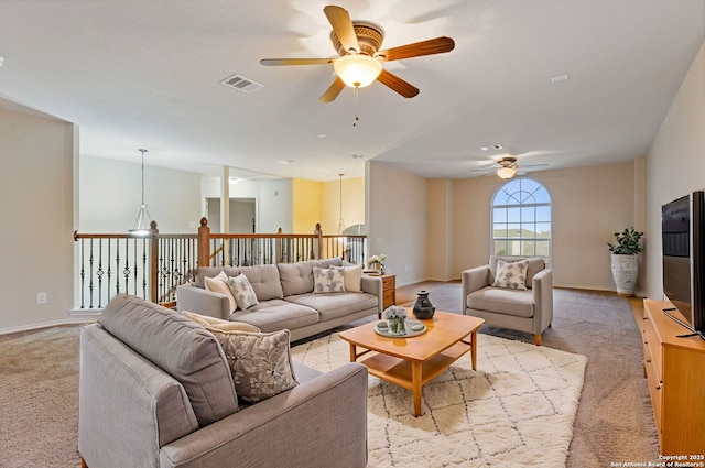 living room featuring ceiling fan and light carpet