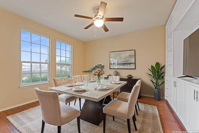 dining space with wood-type flooring and ceiling fan