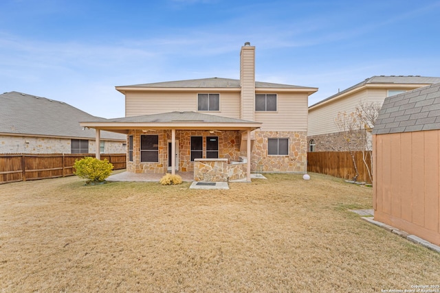 rear view of house featuring a patio, a lawn, and a storage shed