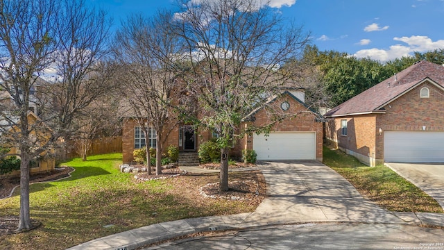 view of front facade featuring brick siding, concrete driveway, a front yard, fence, and a garage