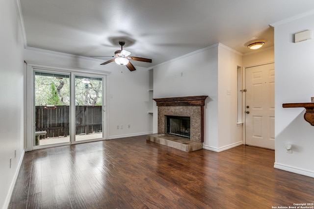 unfurnished living room featuring crown molding, ceiling fan, dark hardwood / wood-style floors, and a tiled fireplace