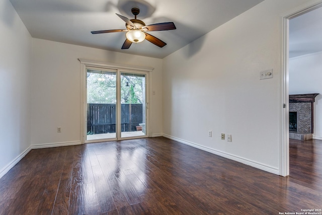 empty room with ceiling fan and dark hardwood / wood-style flooring