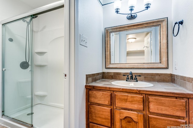 bathroom with vanity and a shower with shower door