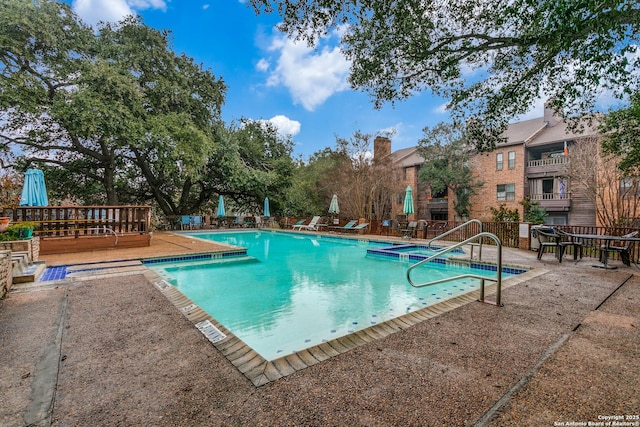 view of pool with a deck and a patio area