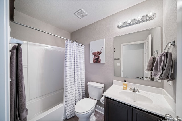 full bathroom with vanity, toilet, a textured ceiling, and shower / bath combo