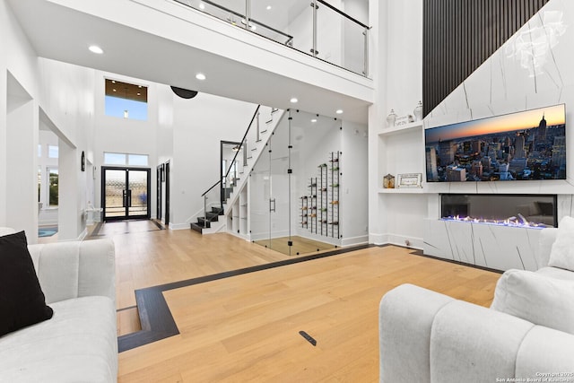 living room with hardwood / wood-style floors and a high ceiling