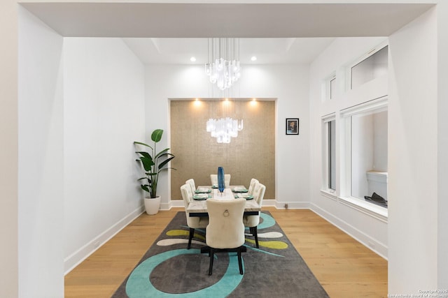 dining room featuring an inviting chandelier and hardwood / wood-style flooring