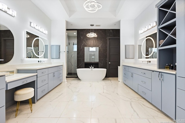 bathroom featuring vanity, independent shower and bath, and a raised ceiling