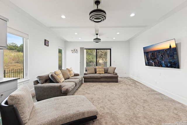 living room featuring beamed ceiling and light colored carpet