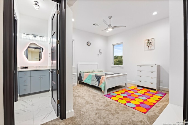 bedroom featuring sink, ceiling fan, and ensuite bathroom