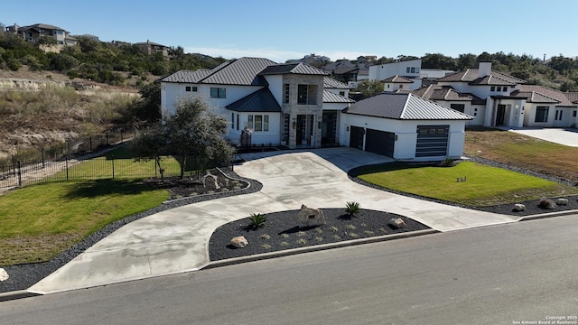 view of front of house featuring a garage and a front yard