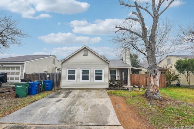 view of front of home featuring fence and a chimney