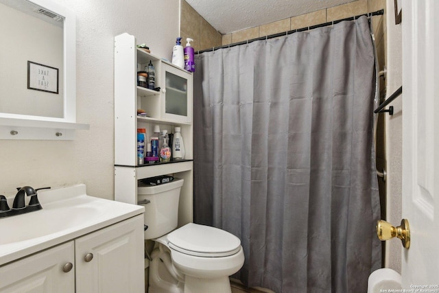 bathroom with toilet, a textured ceiling, vanity, and a shower with curtain