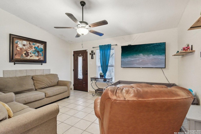 living room featuring lofted ceiling, light tile patterned floors, and ceiling fan