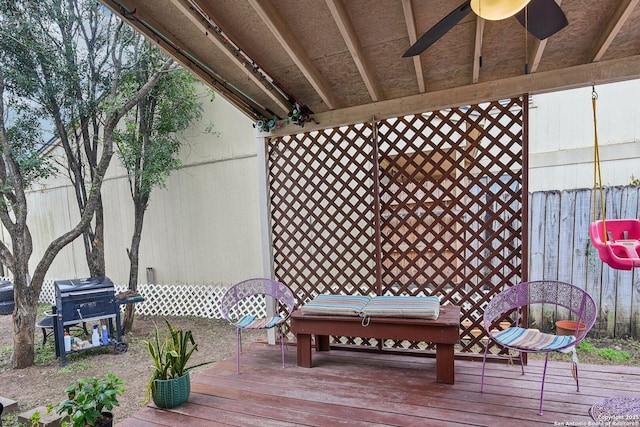 wooden deck with a grill and a ceiling fan