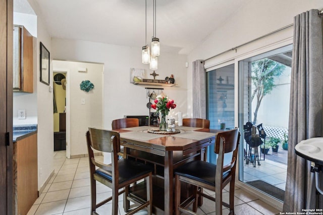 dining space with light tile patterned floors and baseboards