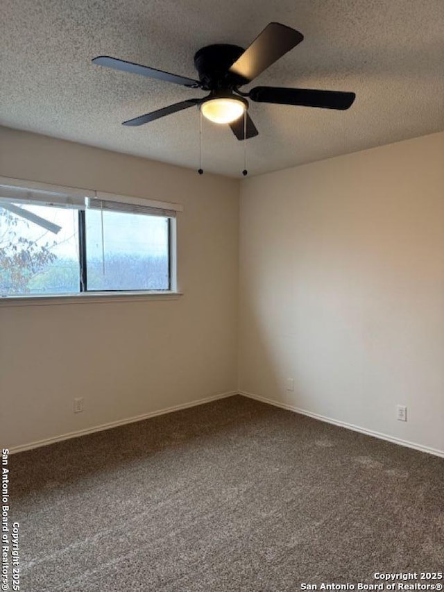 empty room featuring carpet flooring and a textured ceiling