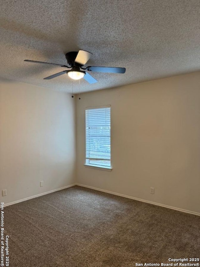 carpeted empty room featuring ceiling fan and a textured ceiling