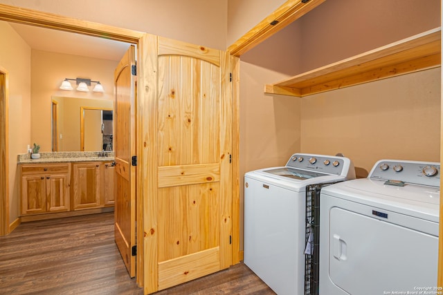 laundry area with washer and dryer and dark wood-type flooring