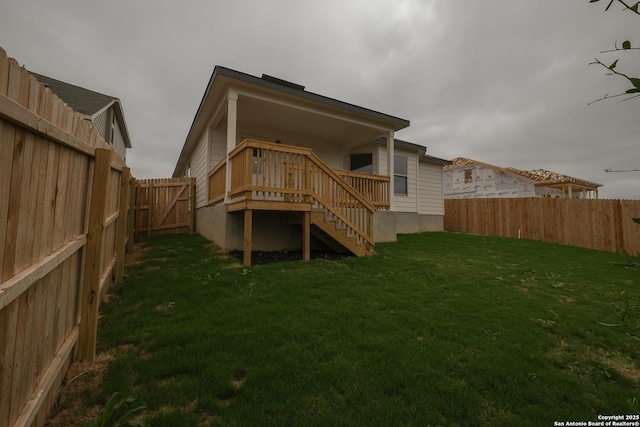 15478 Jake Xing, San Antonio, TX 78245 - back of property featuring a fenced backyard, stairs, and a wooden deck
