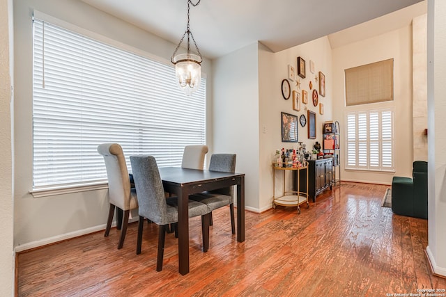 dining space featuring an inviting chandelier and wood-type flooring