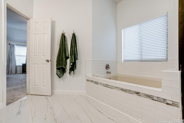 bathroom with tiled tub