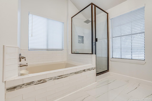 bathroom with independent shower and bath and plenty of natural light