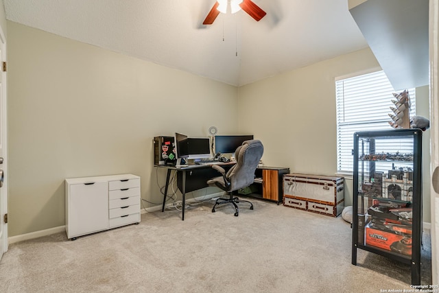 office featuring ceiling fan, vaulted ceiling, and light carpet