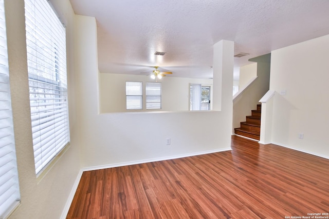 spare room with ceiling fan, hardwood / wood-style floors, and a textured ceiling