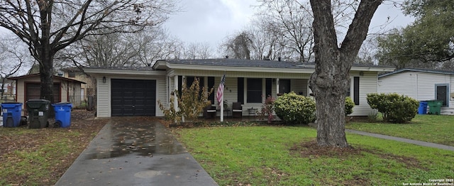 view of front of property featuring a garage, covered porch, and a front lawn