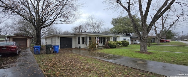 single story home with a garage and a front lawn