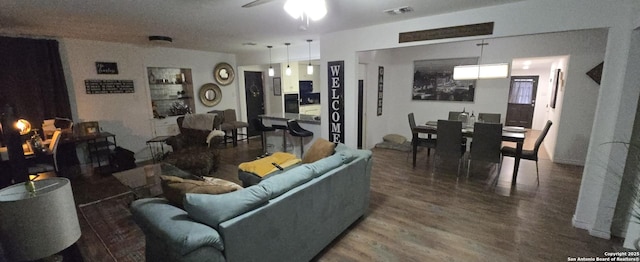 living room with hardwood / wood-style flooring and ceiling fan