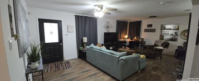 living room with dark wood-type flooring and ceiling fan