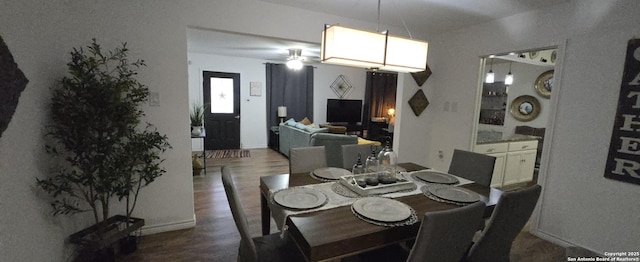 dining area with ceiling fan and dark hardwood / wood-style flooring