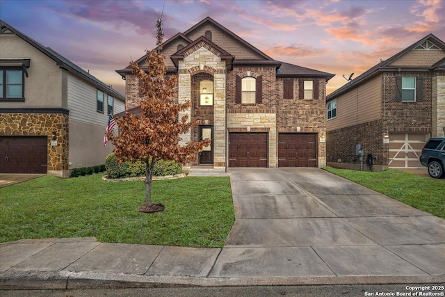 view of front of house featuring a garage and a lawn