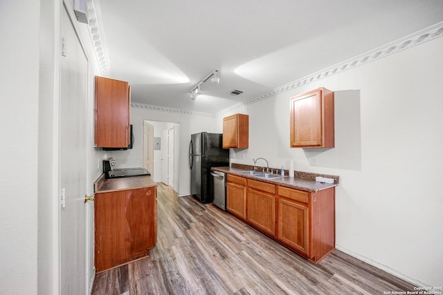 kitchen featuring dishwasher, stove, sink, and light hardwood / wood-style flooring