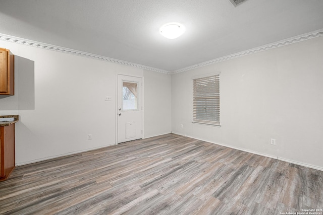 interior space with light hardwood / wood-style floors and a textured ceiling