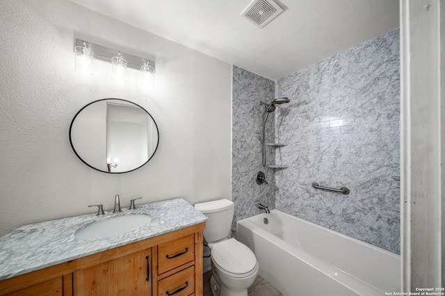 full bathroom with vanity, tiled shower / bath combo, and toilet