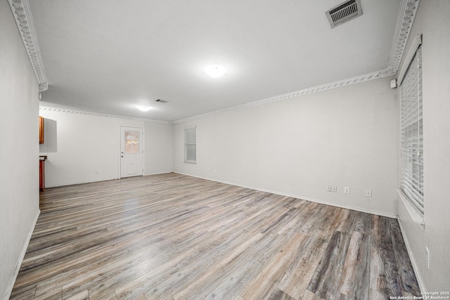 unfurnished room featuring crown molding and hardwood / wood-style floors