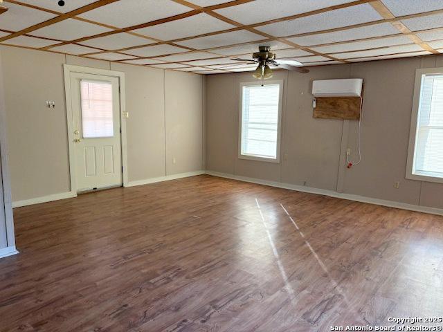 unfurnished room with hardwood / wood-style flooring and ceiling fan